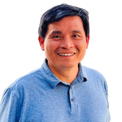Portrait of a smiling man in a light blue polo shirt, facing the camera.